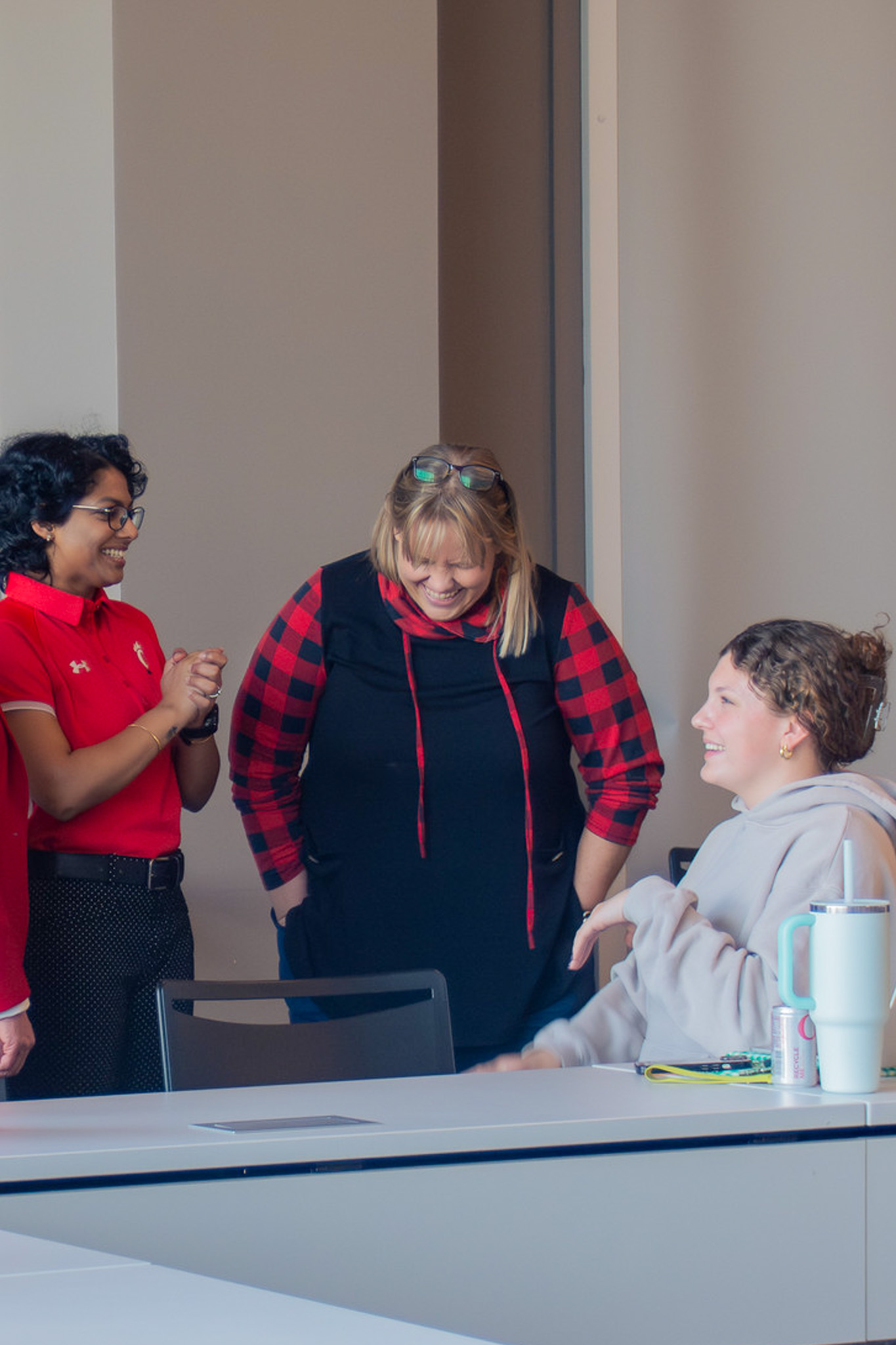 Three women engaged in conversation at a table