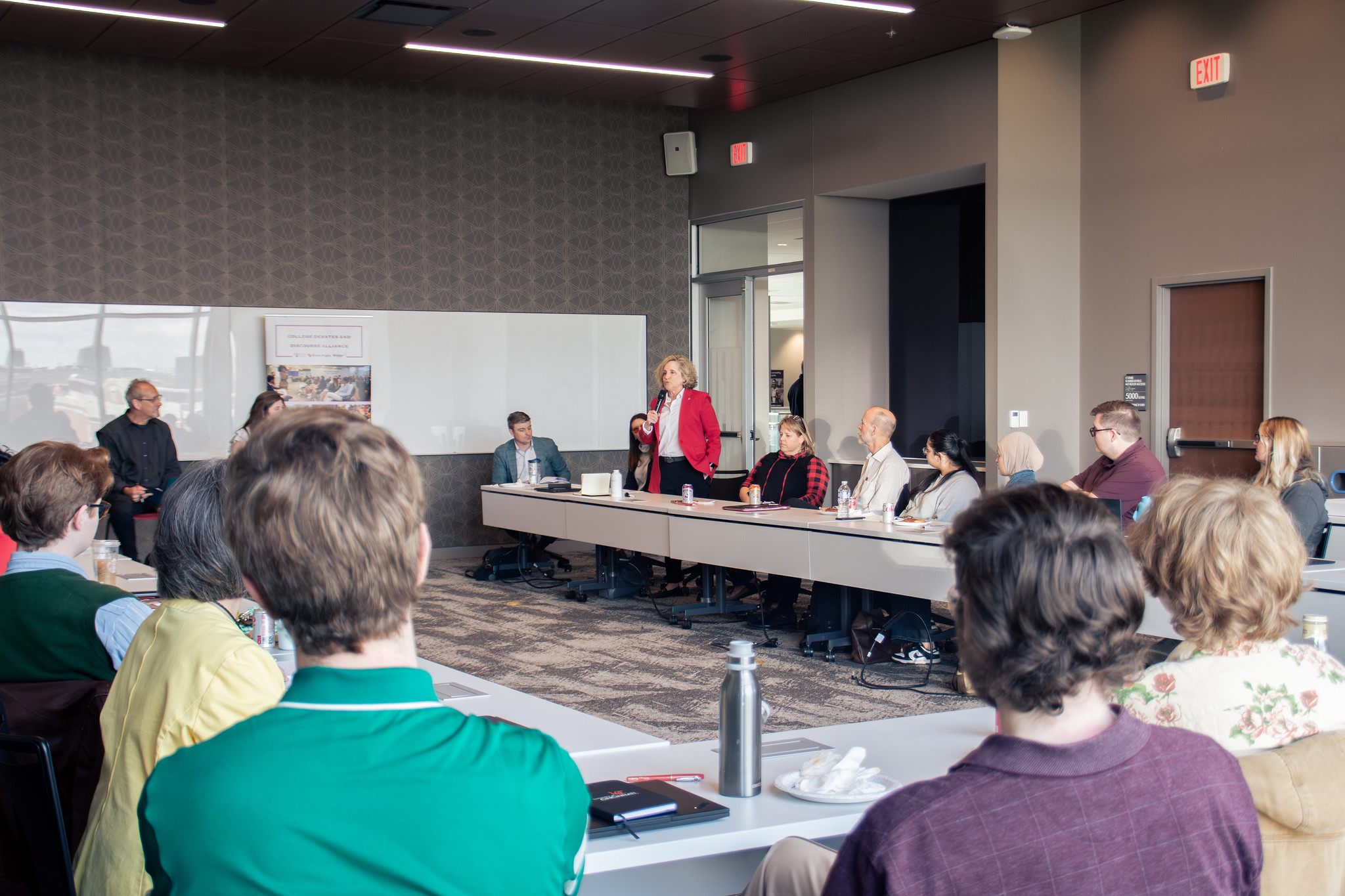 Panel discussion with speaker in red jacket